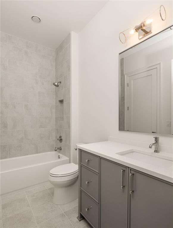 1064 Lupo Loop Chattahoochee Hills, GA 30268 - Photo 32 of 40 a bathroom with a sink a toilet and shower