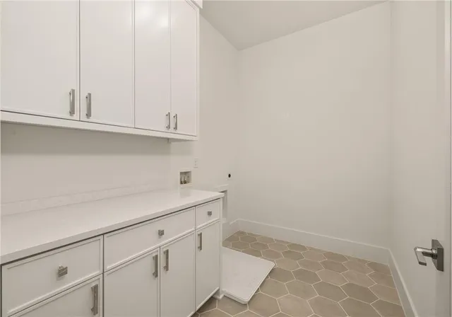 a view of a kitchen with white cabinets