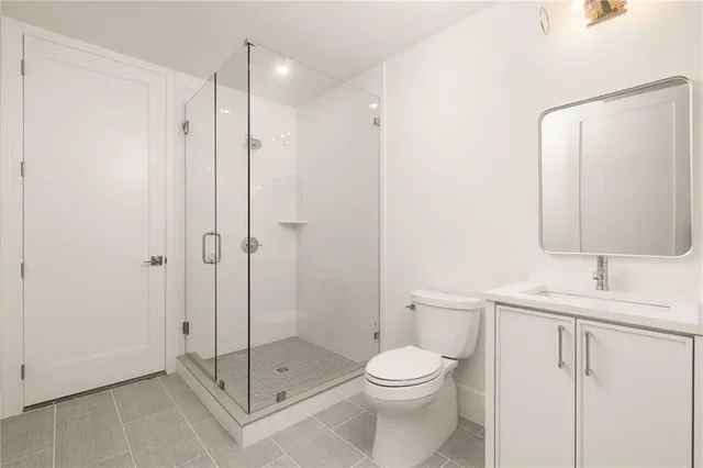 a bathroom with a toilet a sink and a shower