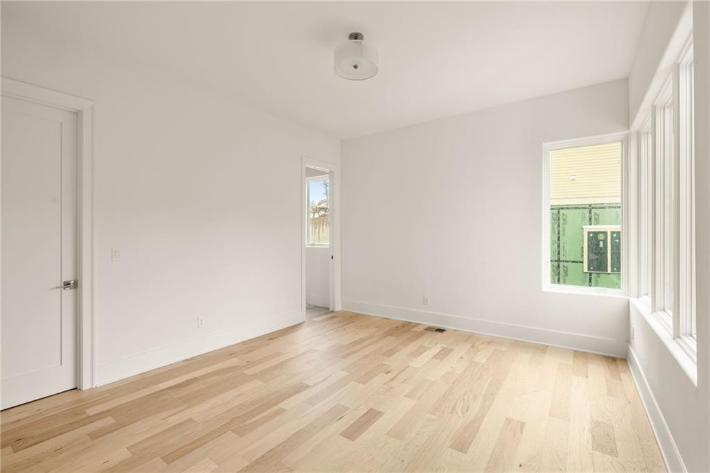1064 Lupo Loop Chattahoochee Hills, GA 30268 - Photo 36 of 40 an empty room with wooden floor and windows