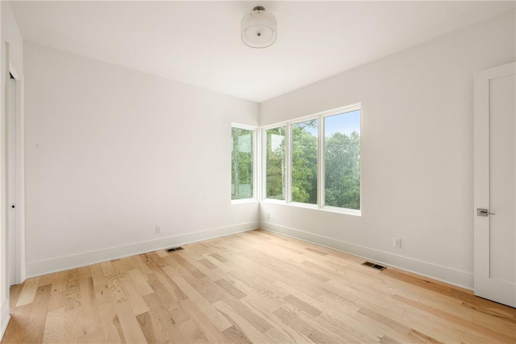 1064 Lupo Loop Chattahoochee Hills, GA 30268 - Photo 37 of 40 a view of empty room with wooden floor and fan