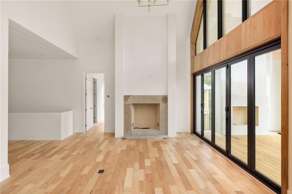 1064 Lupo Loop Chattahoochee Hills, GA 30268 - Photo 9 of 40 a view of an empty room with wooden floor and a window