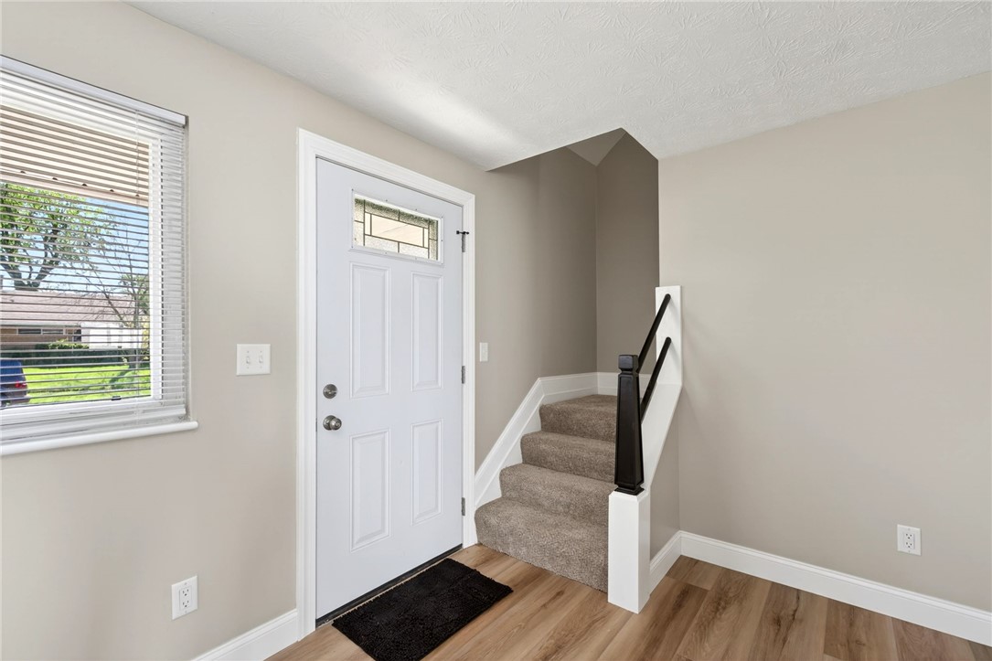 5975 Rosalie Road Dayton, OH 45424 - Photo 3 of 48 A welcoming entryway features elegant flooring, a well-crafted staircase, and a bright window.