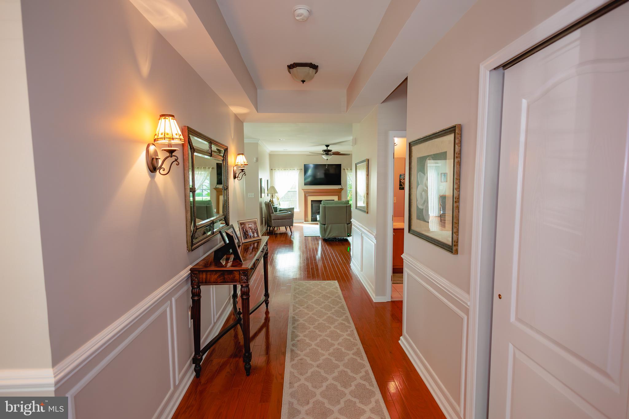 302 Gosling Way Glassboro, NJ 08028 - Photo 11 of 37 a view of a hallway view with living room and wooden floor