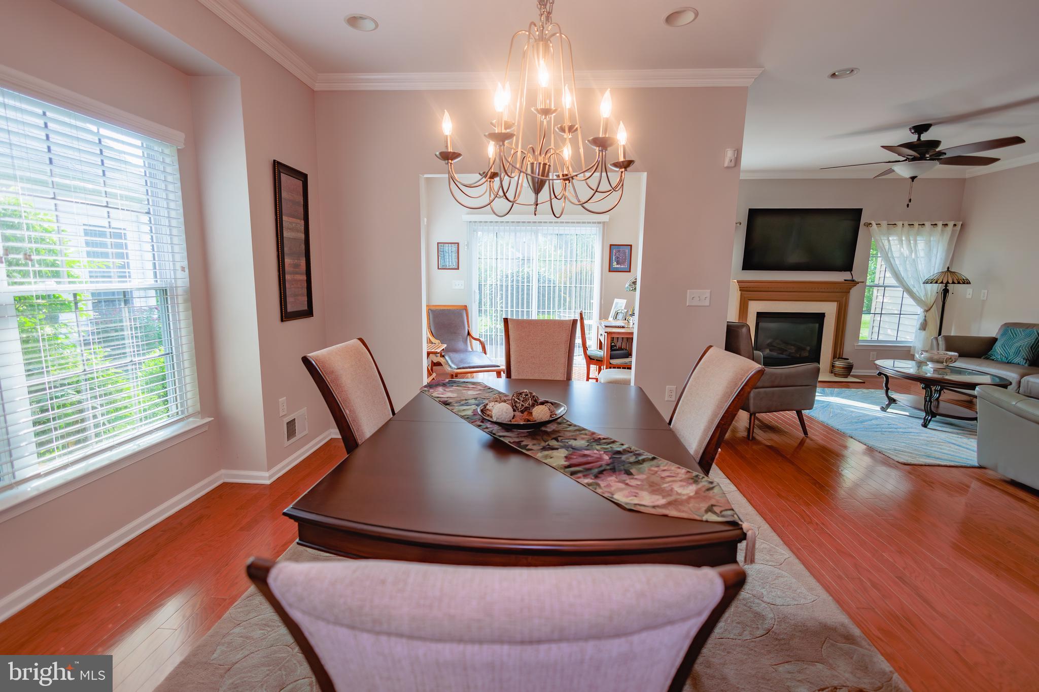 302 Gosling Way Glassboro, NJ 08028 - Photo 12 of 37 a living room with furniture a fireplace and a chandelier