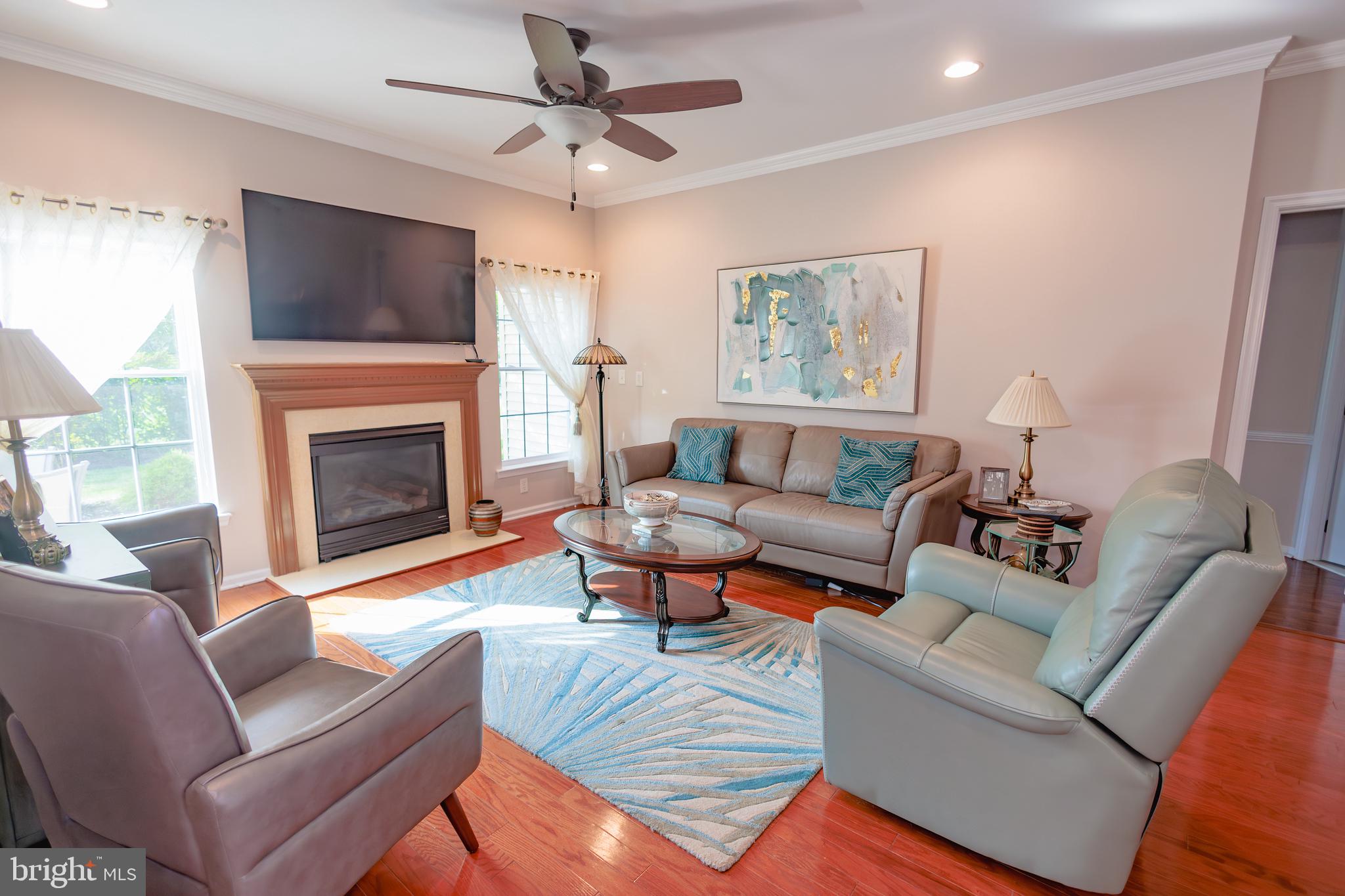 302 Gosling Way Glassboro, NJ 08028 - Photo 14 of 37 a living room with furniture a fireplace and a flat screen tv