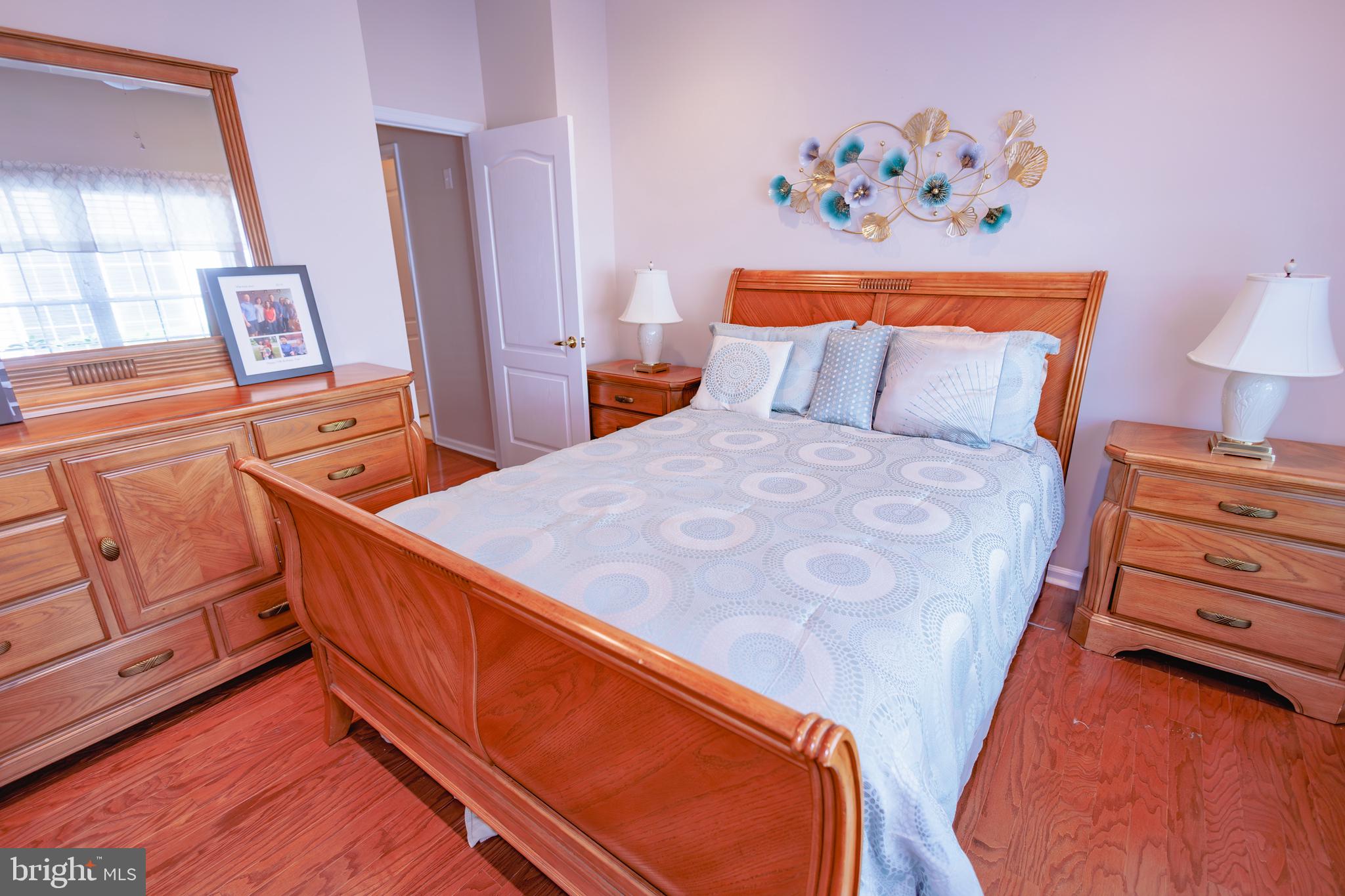 302 Gosling Way Glassboro, NJ 08028 - Photo 27 of 37 a bedroom with a bed and dresser with mirror