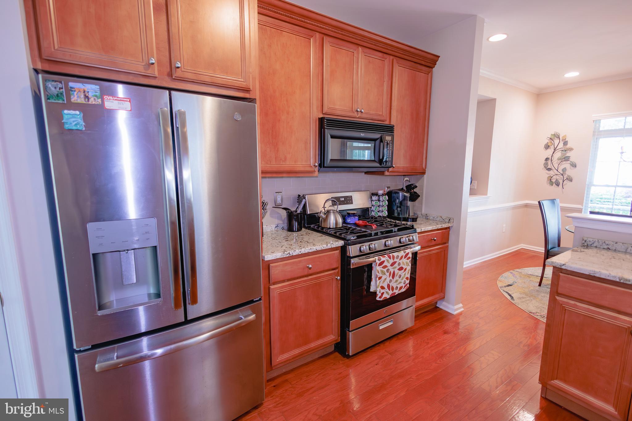 302 Gosling Way Glassboro, NJ 08028 - Photo 8 of 37 a kitchen with granite countertop stainless steel appliances a refrigerator a stove top oven and cabinets