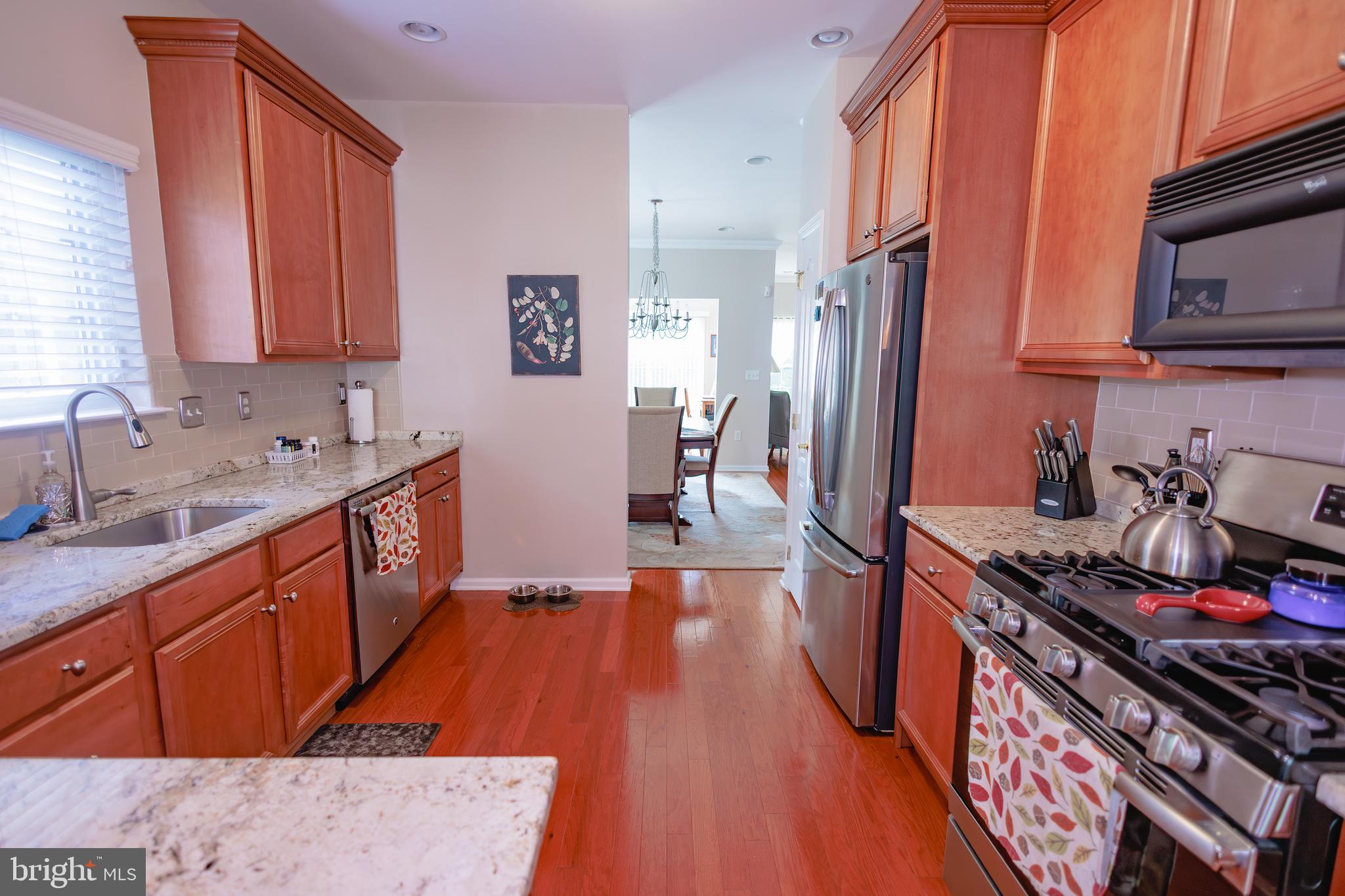 302 Gosling Way Glassboro, NJ 08028 - Photo 9 of 37 a kitchen with stainless steel appliances a sink stove and refrigerator
