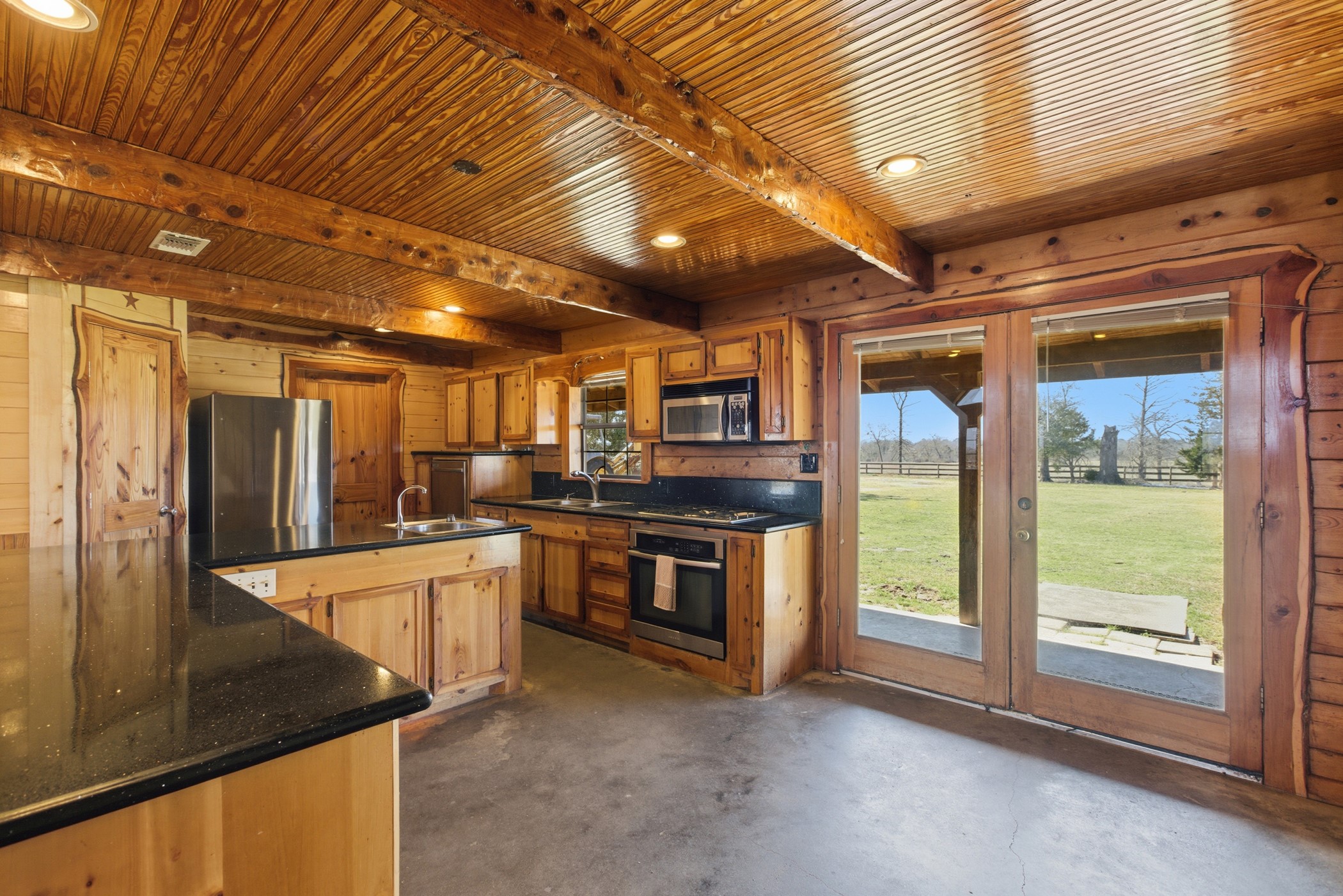 27185 Muckelroy Road Hempstead, TX 77445 - Photo 23 of 48 a kitchen with stainless steel appliances granite countertop a sink and a refrigerator