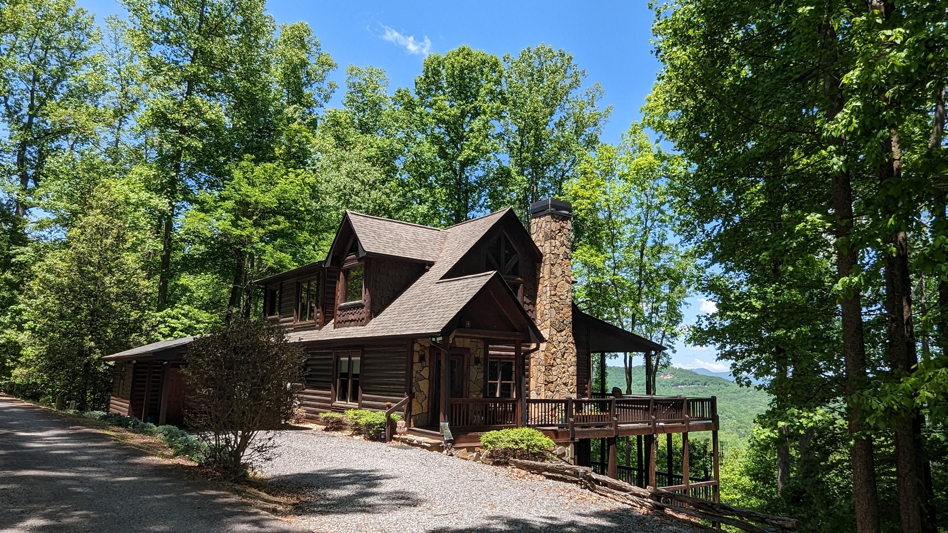 a front view of a house with a tree