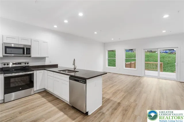 a kitchen with granite countertop a sink and a window
