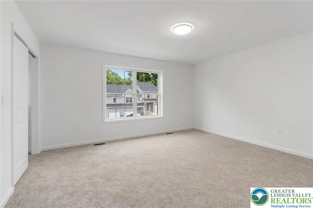 a bathroom with a granite countertop sink a toilet and a mirror