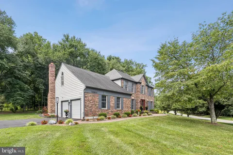 a view of a house with a yard porch and sitting area