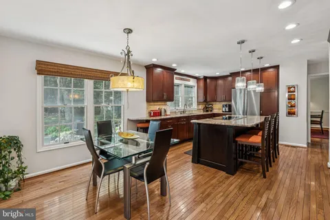 a dining room with furniture a window and wooden floor