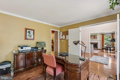 a living room with fireplace furniture and a wooden floor