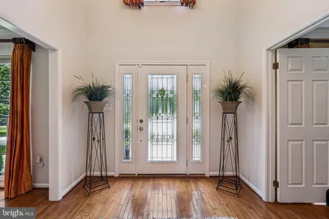 a living room with a bed furniture and a large window