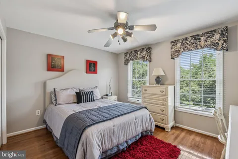 a bedroom with a bed chair and a window