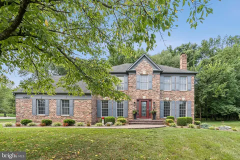 a front view of a house with a yard table and chairs
