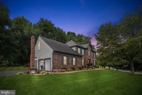 a front view of a house with a yard table and chairs