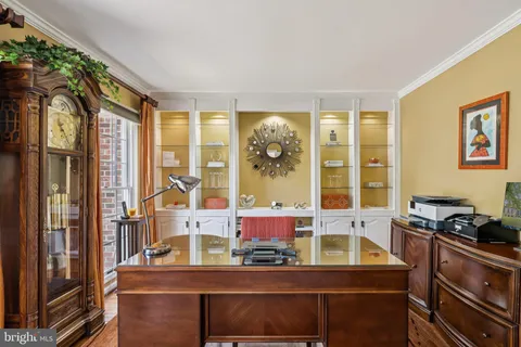 a dining room with furniture and a window