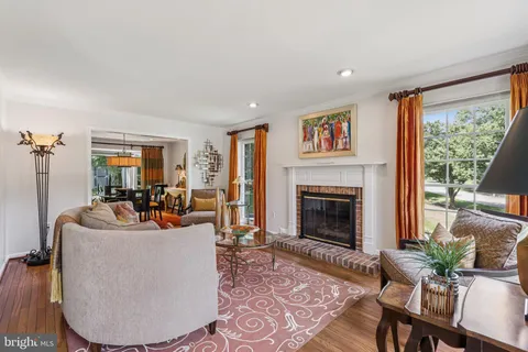 a living room with furniture large window and a fireplace