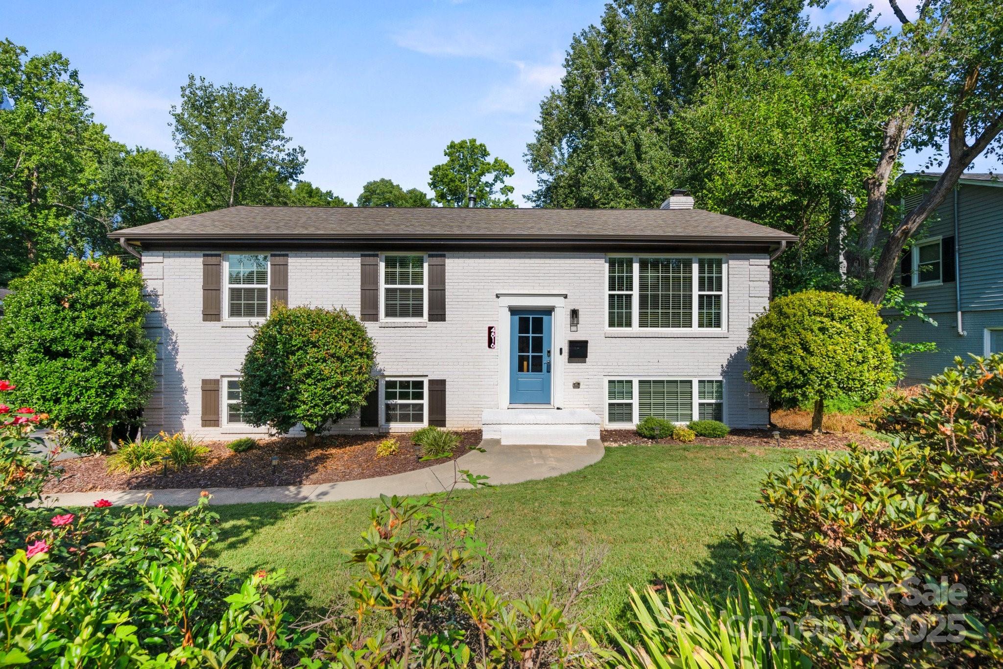 a view of a house with a yard and sitting area