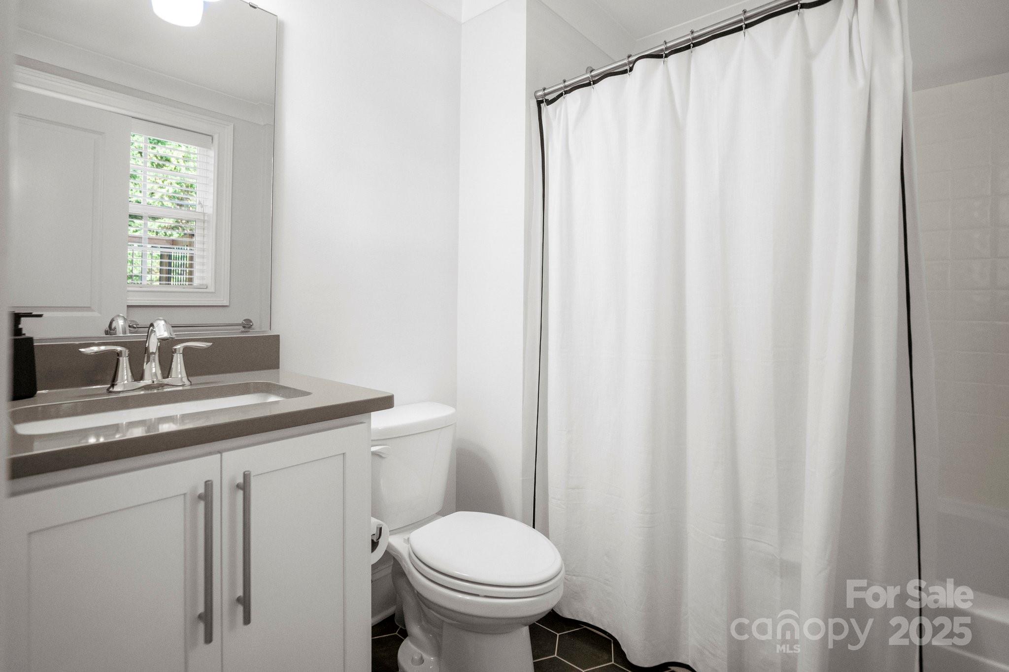 4816 Fairheath Road Charlotte, NC 28210 - Photo 21 of 35 a bathroom with a granite countertop sink and a toilet