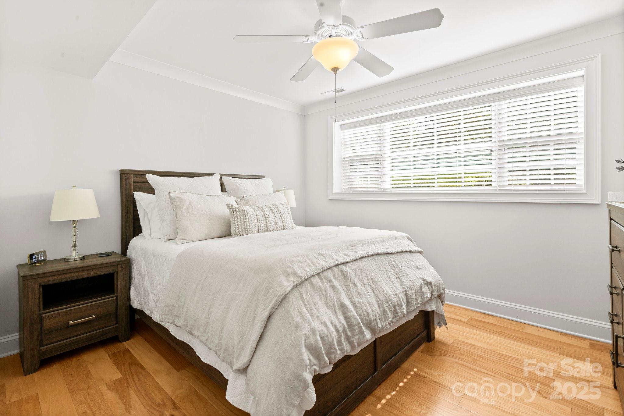 4816 Fairheath Road Charlotte, NC 28210 - Photo 23 of 35 a bedroom with a bed and a tv