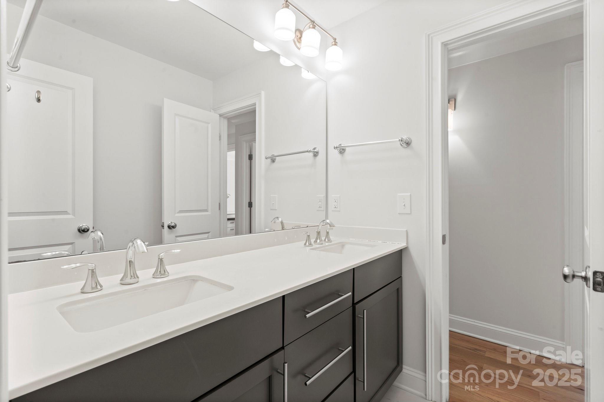 4816 Fairheath Road Charlotte, NC 28210 - Photo 27 of 35 a bathroom with a sink double vanity and a mirror