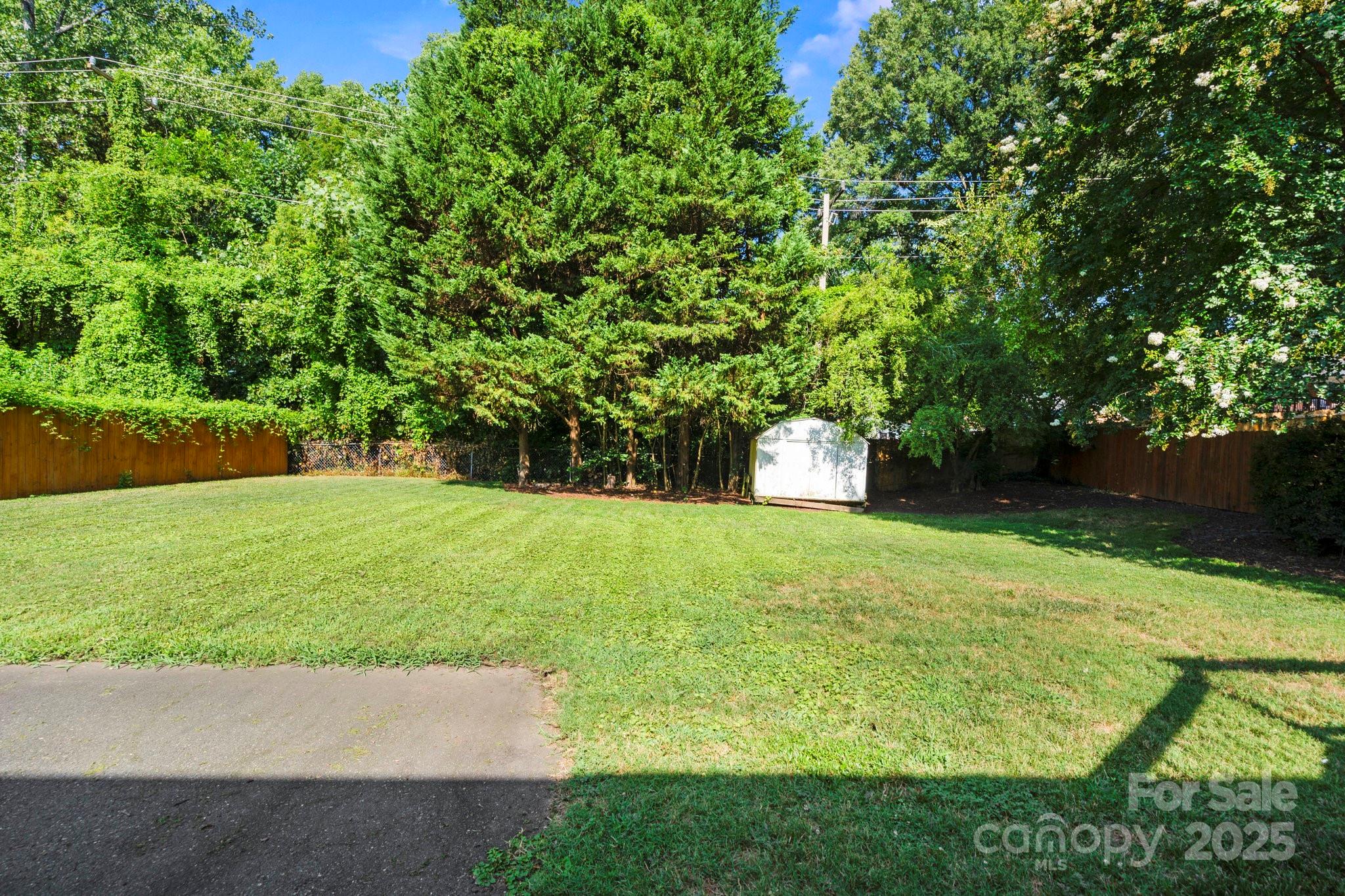 4816 Fairheath Road Charlotte, NC 28210 - Photo 34 of 35 a backyard of a house with lots of green space