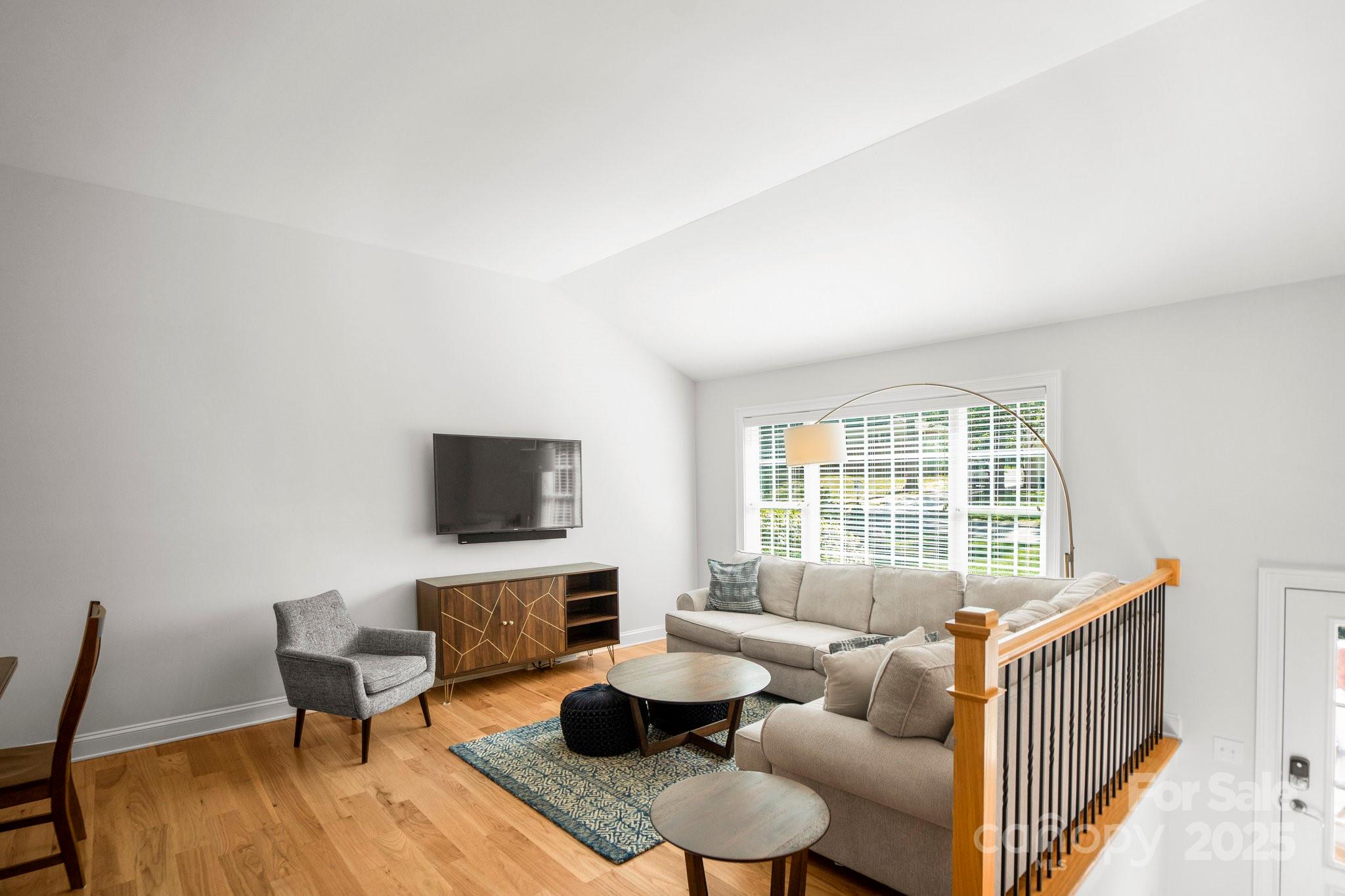 4816 Fairheath Road Charlotte, NC 28210 - Photo 6 of 35 a living room with furniture and a flat screen tv