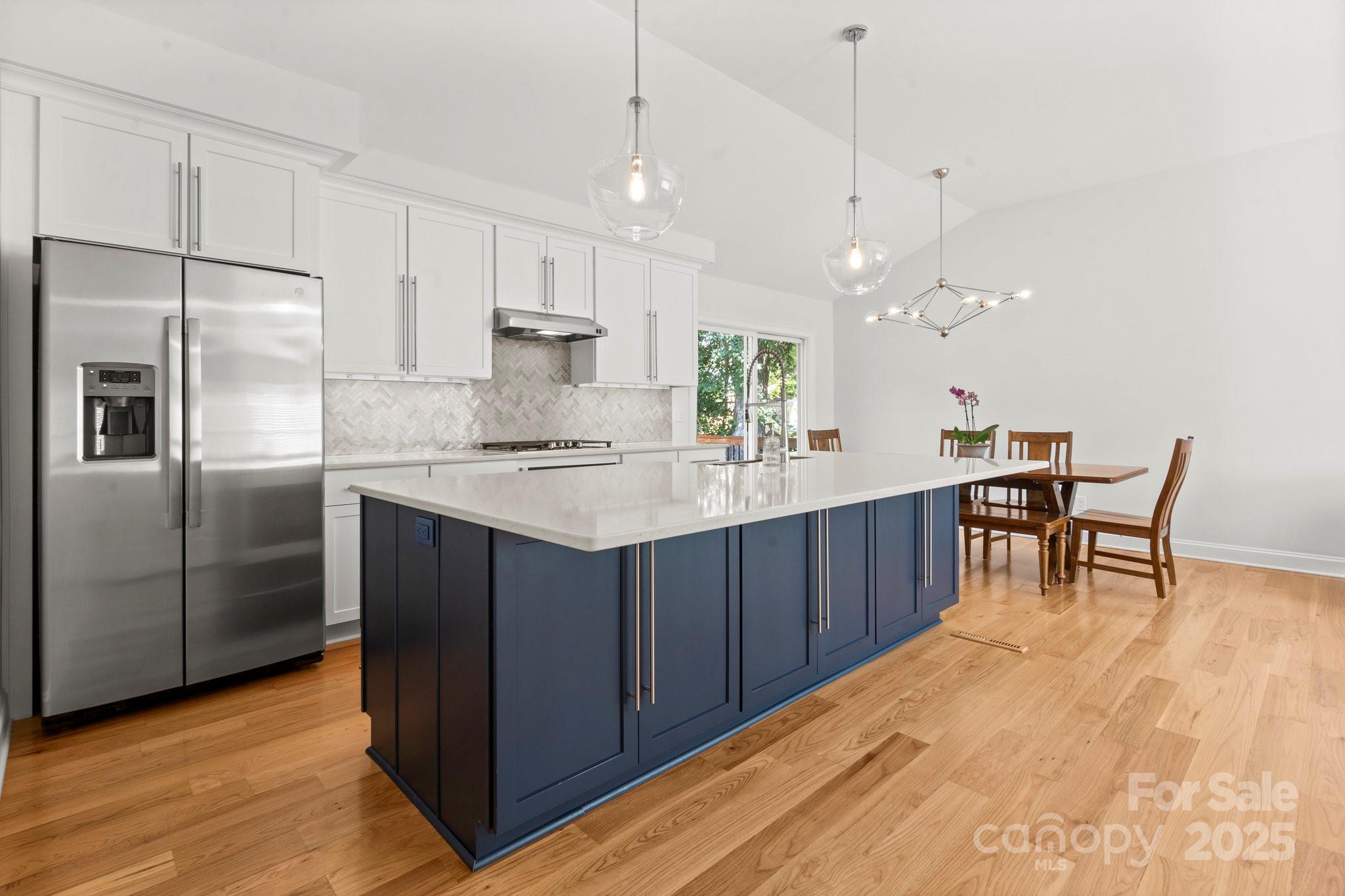 4816 Fairheath Road Charlotte, NC 28210 - Photo 10 of 35 a kitchen with kitchen island a counter top space appliances and cabinets