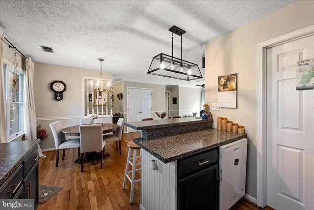 a kitchen with stainless steel appliances granite countertop a stove and a table