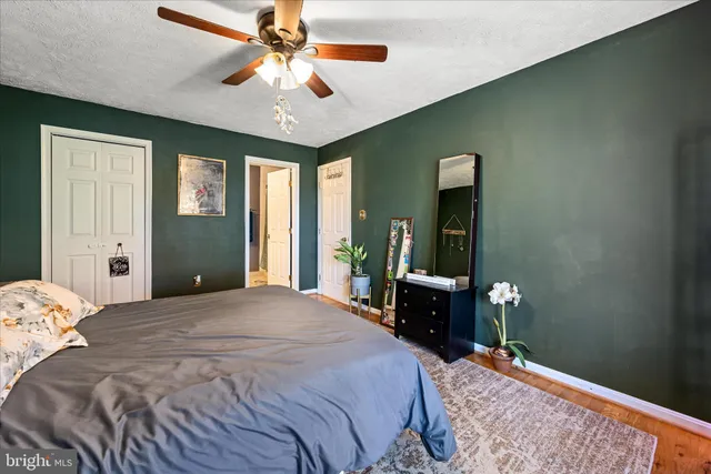 a bedroom with a bed dresser and a window