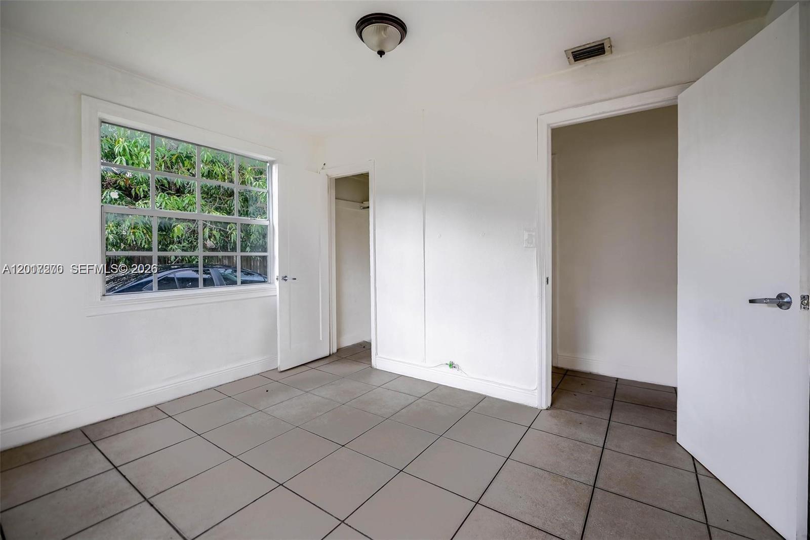 2800 Southwest 16th Terrace Miami, FL 33145 - Photo 11 of 17 a view of an empty room with a window