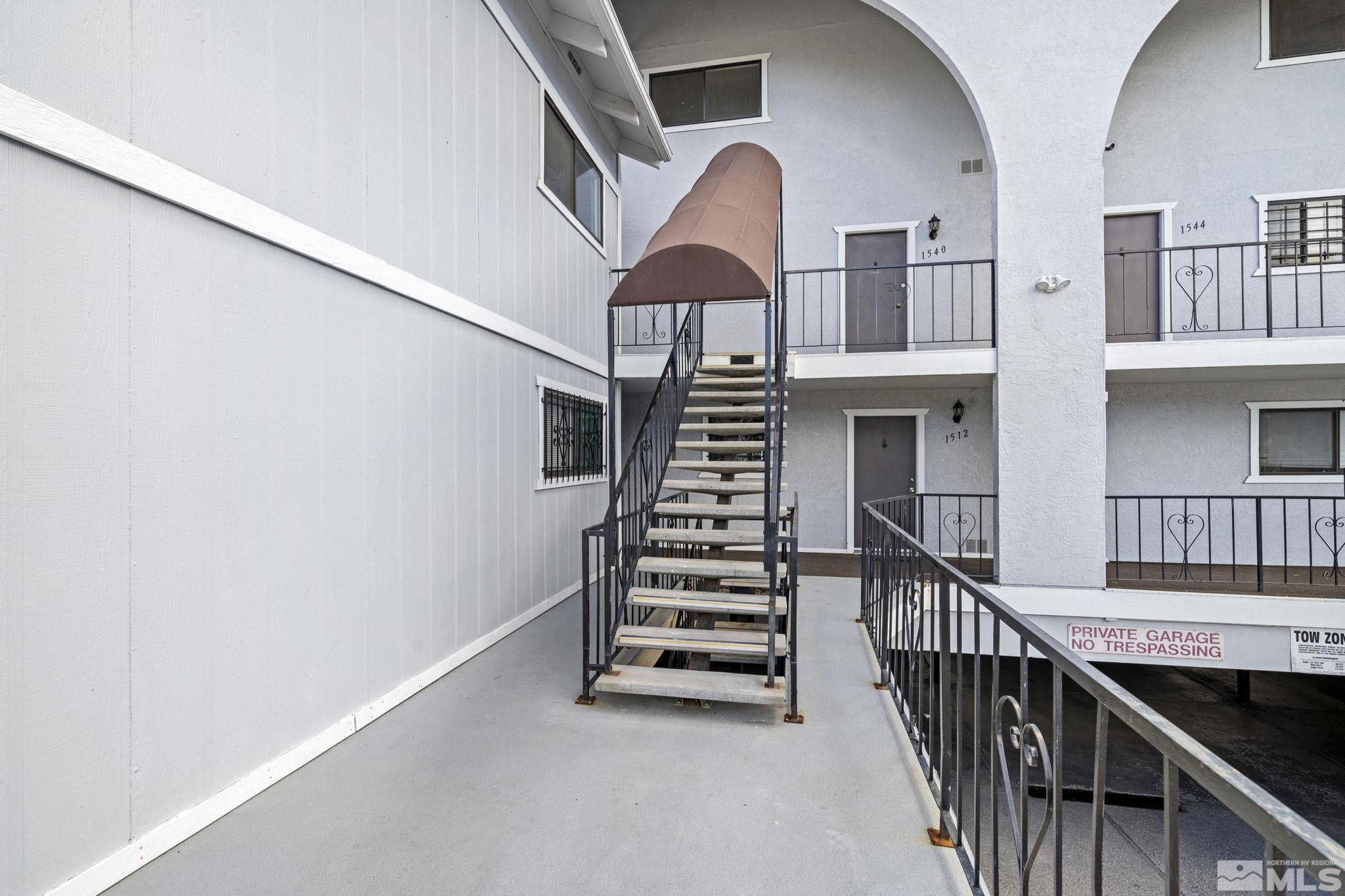 1508 Carlin Street Reno, NV 89503 - Photo 27 of 29 a view of a hallway with stairs and wooden floor