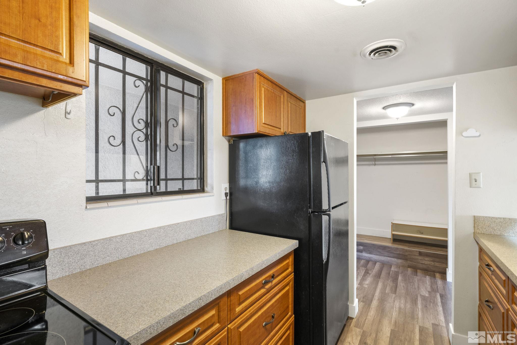 1508 Carlin Street Reno, NV 89503 - Photo 5 of 29 a kitchen with a refrigerator and a stove top oven
