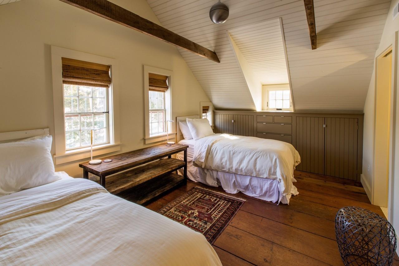 53 Depot Road Truro, MA 02666 - Photo 11 of 29 a bedroom with a bed and wooden floor