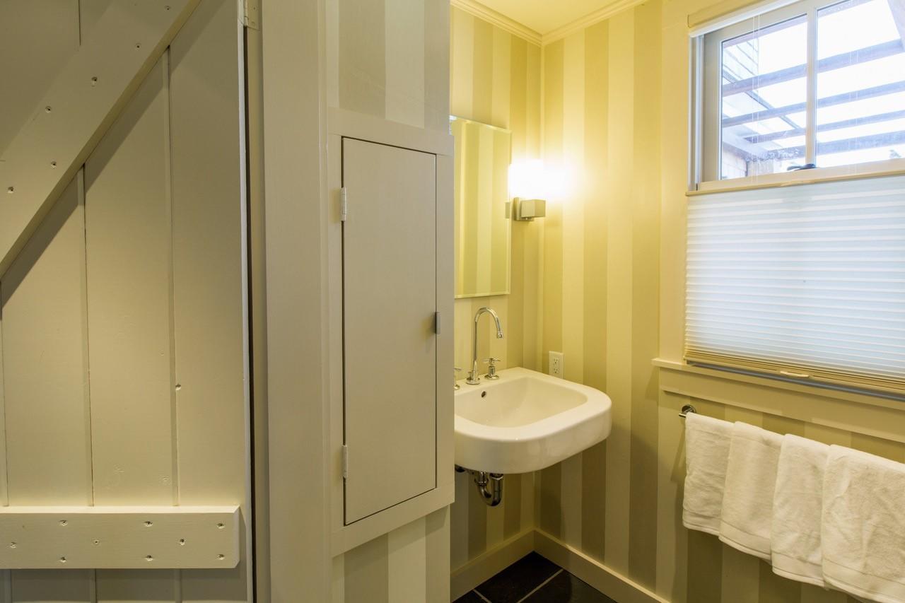 53 Depot Road Truro, MA 02666 - Photo 14 of 29 a bathroom with a sink a mirror and a shower