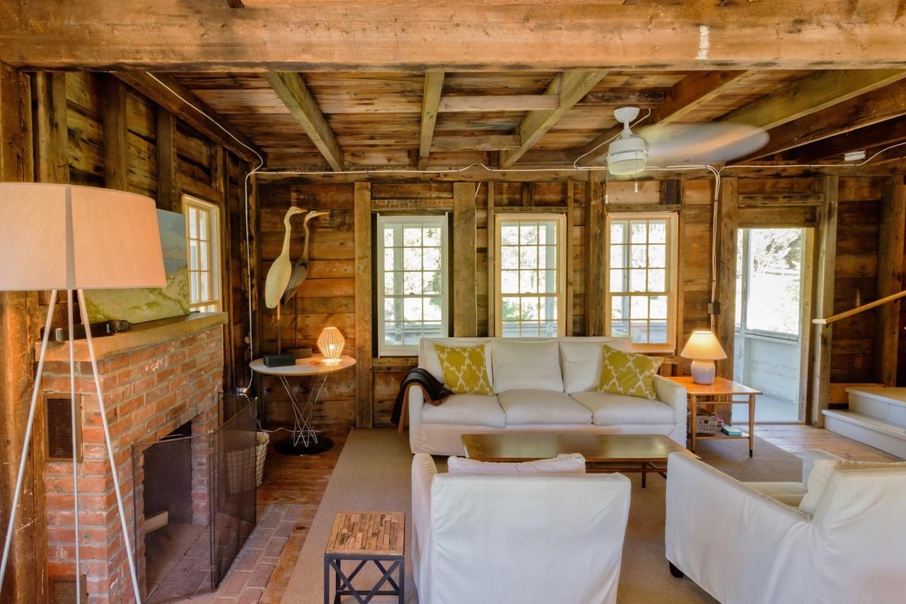 53 Depot Road Truro, MA 02666 - Photo 26 of 29 a living room with furniture and a large window
