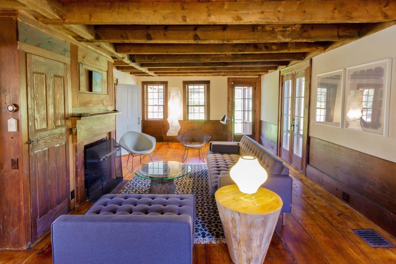 53 Depot Road Truro, MA 02666 - Photo 5 of 29 a living room with furniture and a fireplace