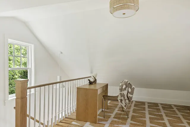 a picture of a room with wooden floor and windows