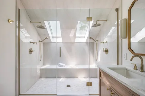a bathroom with a granite countertop sink mirror bathtub and shower