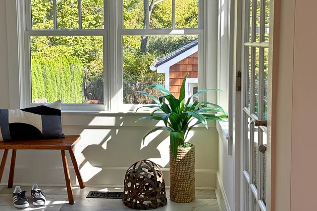 a view of a livingroom with furniture and floor to ceiling window