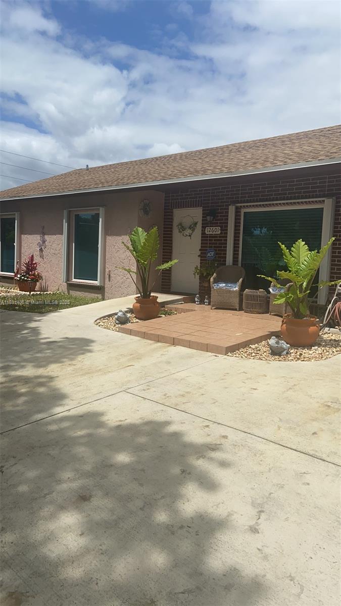 12601 Southwest 268th Street Homestead, FL 33032 - Photo 14 of 17 a view of a patio in front of the house