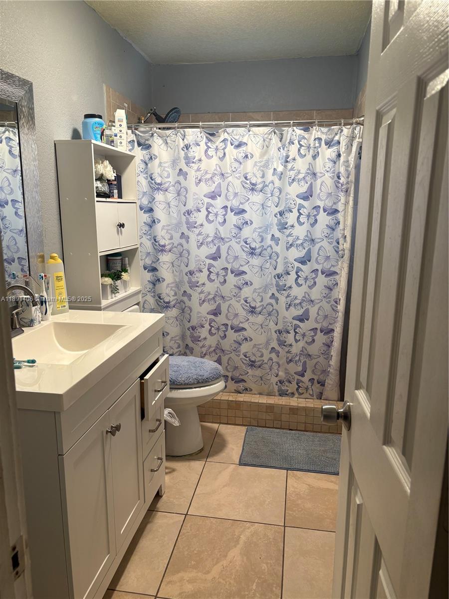 12601 Southwest 268th Street Homestead, FL 33032 - Photo 15 of 17 a bathroom with a sink toilet and shower