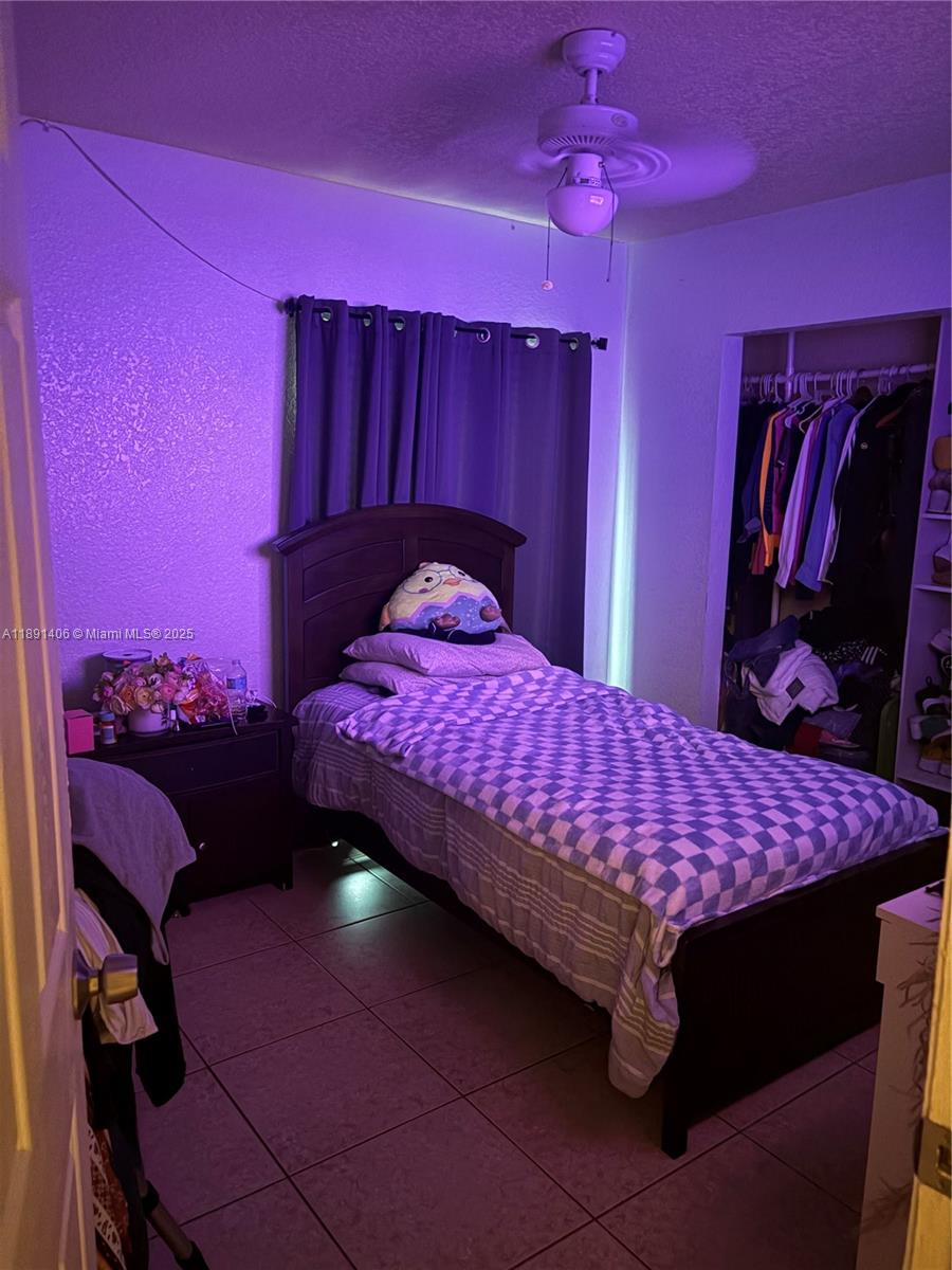 12601 Southwest 268th Street Homestead, FL 33032 - Photo 7 of 17 a bedroom with a bed and a mirror