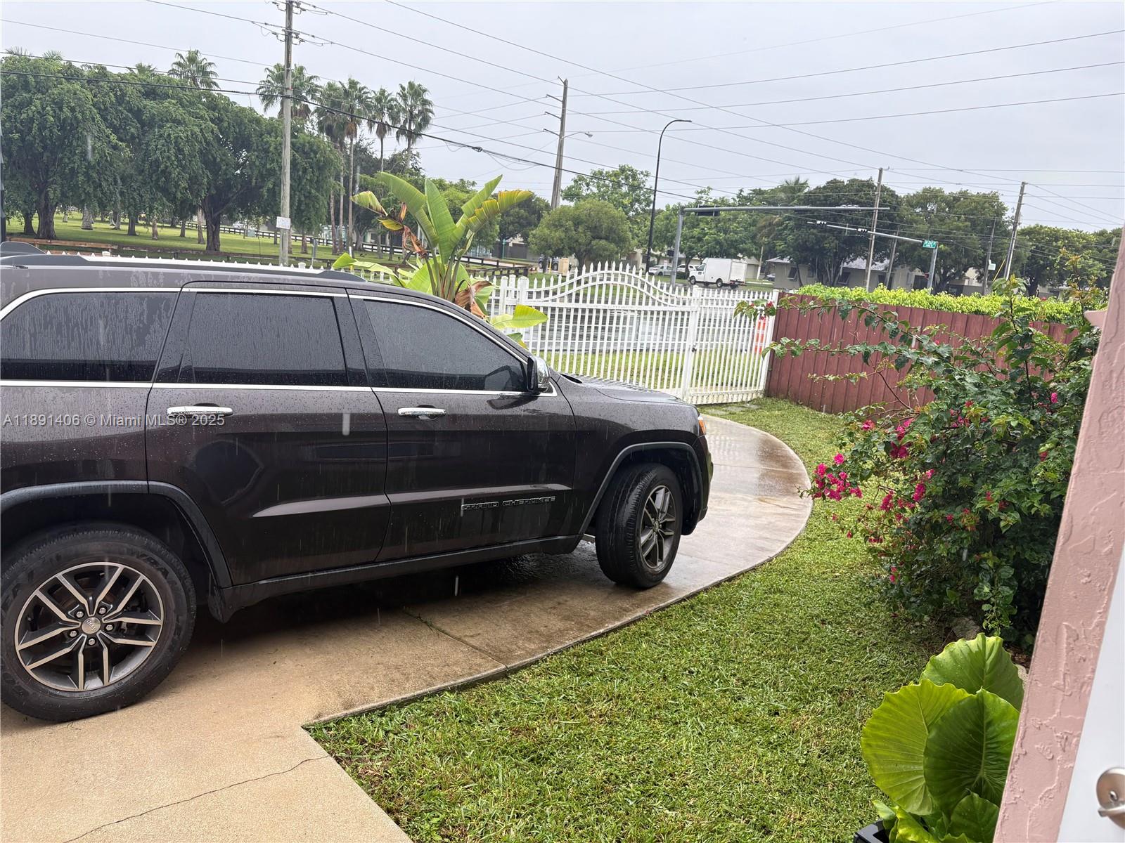 12601 Southwest 268th Street Homestead, FL 33032 - Photo 9 of 17 a view of a car parked in back yard of the house
