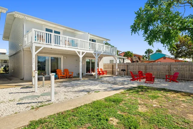 a living room with furniture a couch and a potted plant